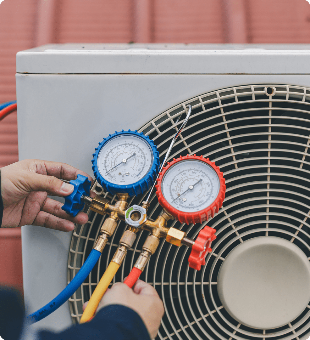 HVAC technician using manifold gauge set