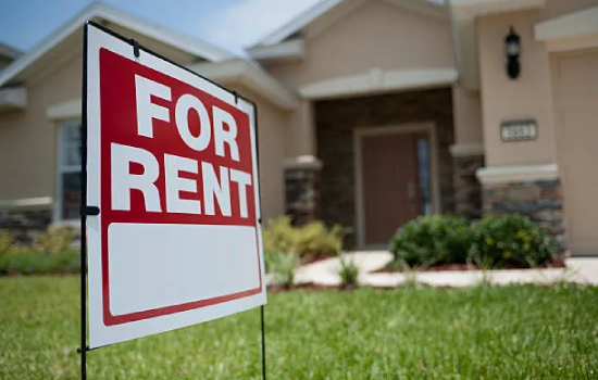 House with for rent sign on lawn
