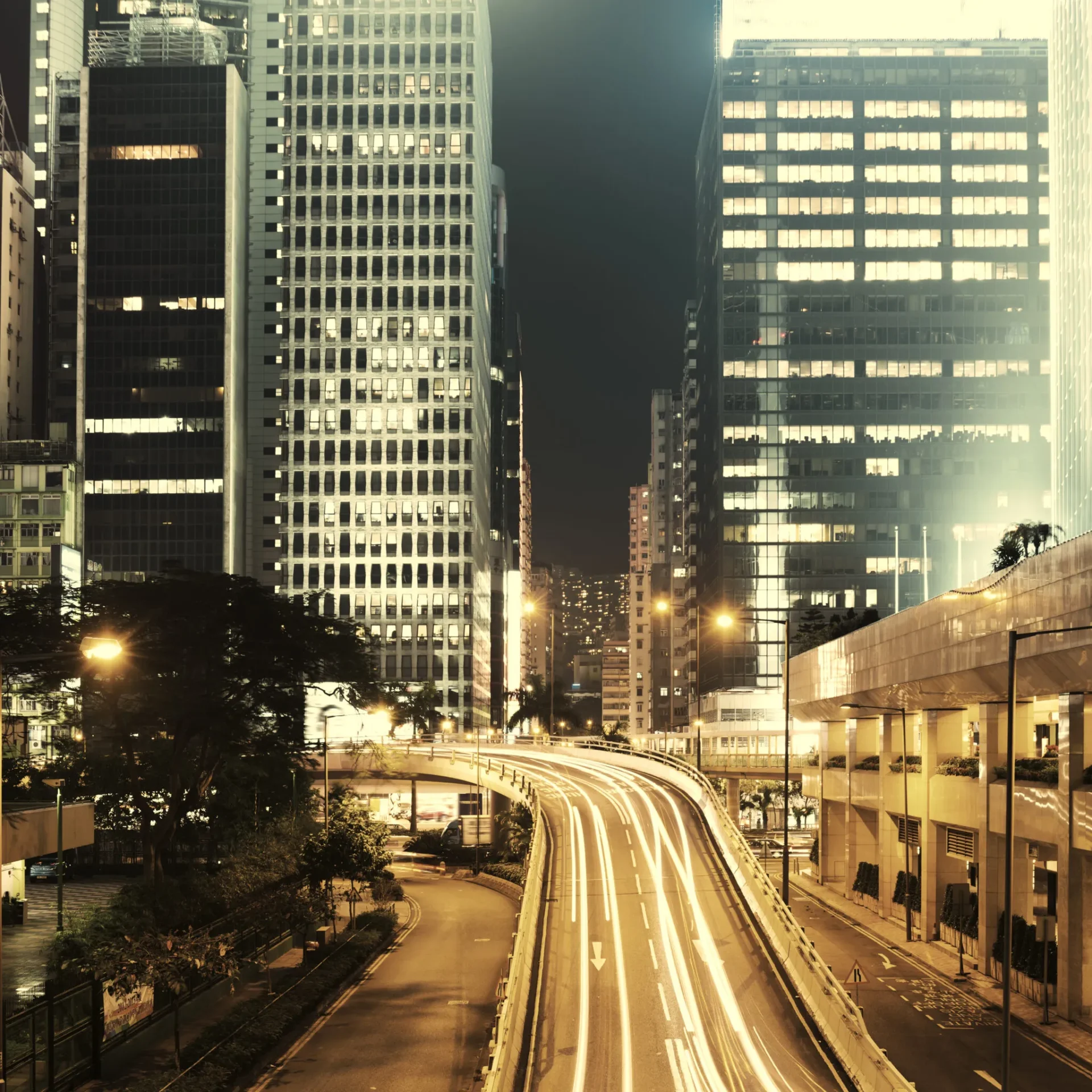 Nighttime cityscape featuring modern buildings and roads