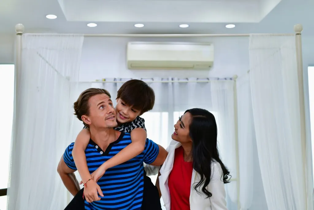 Child piggybacking on parent's shoulders