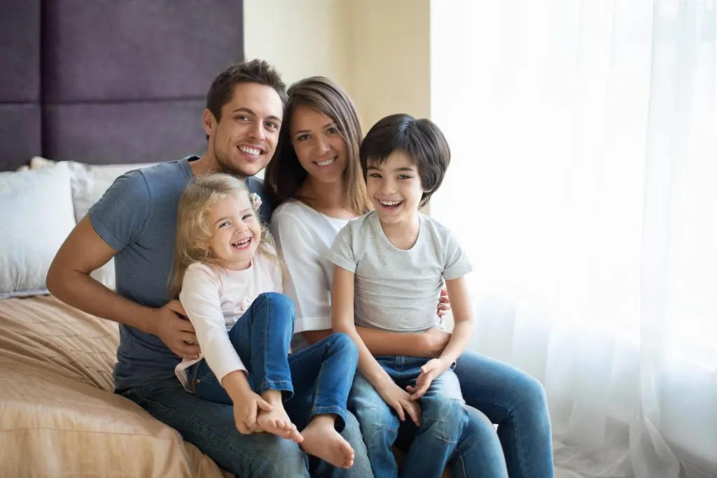 Smiling parents with two young children